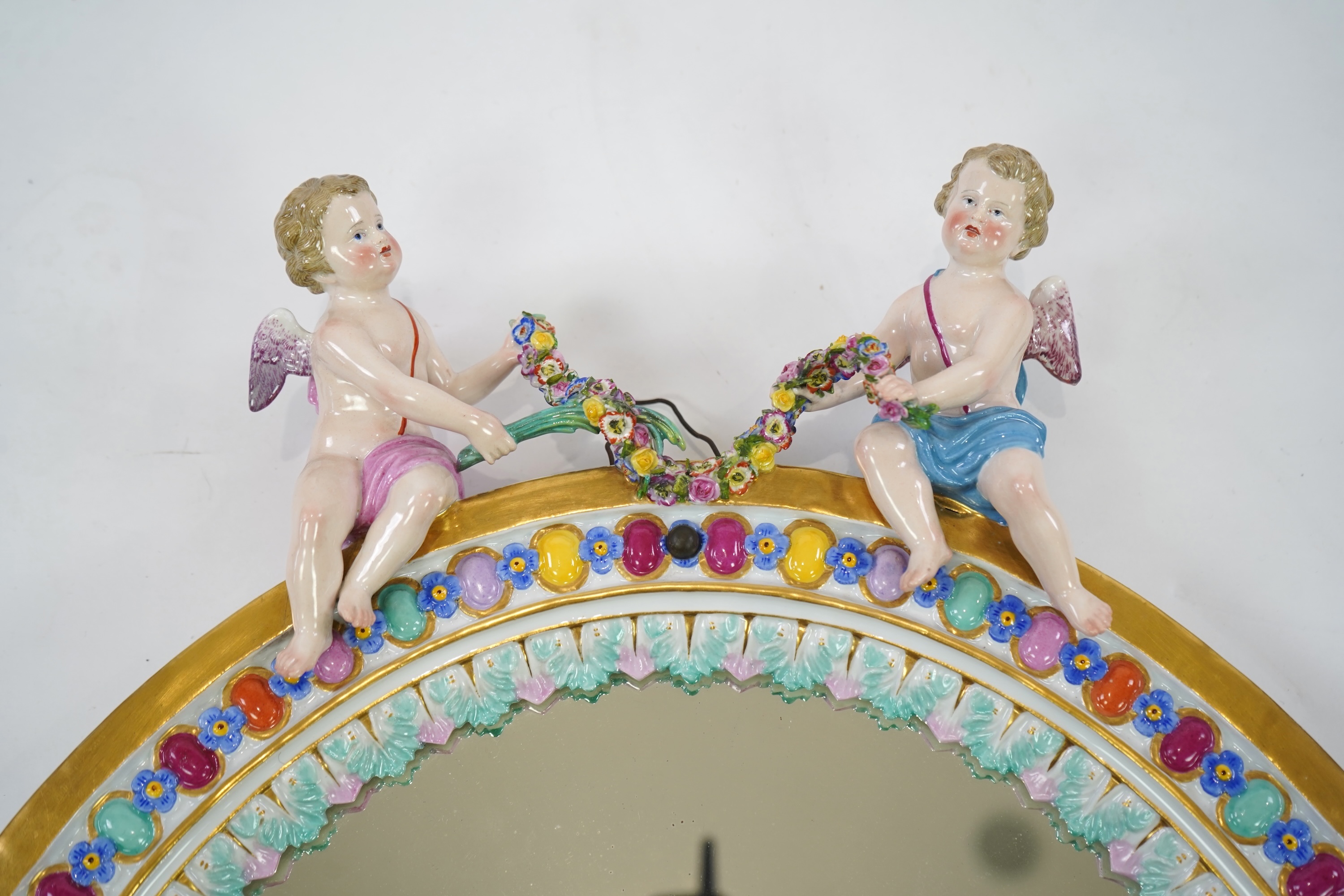 A Meissen figural oval mirror, late 19th century
